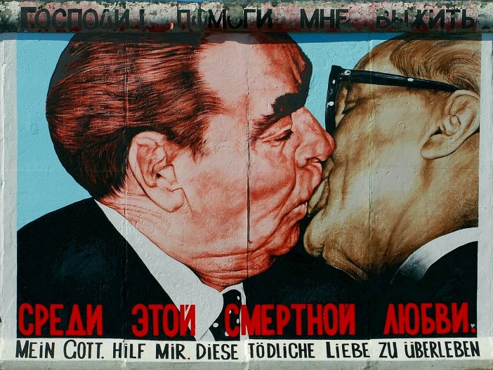 “Mein Gott, hilf mir, diese tödliche Liebe zu überleben (My God, help me survive this deadly love)” from Dmitri Wrubel at the East Side Gallery, 2009  The picture shows the painting of the kissing politicians on the wall. The title of the artwork is in Russian and in German.